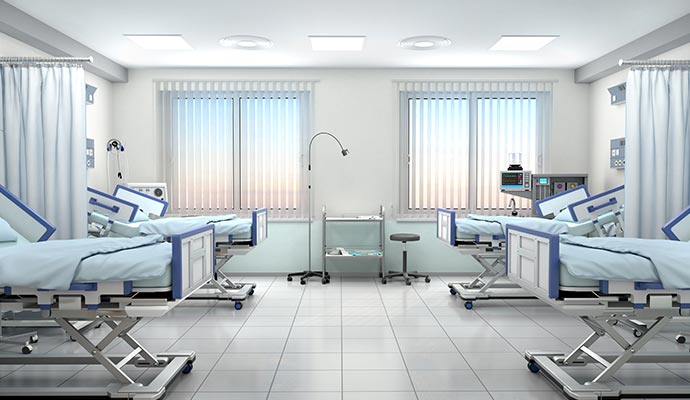 A clean and bright health care facility room with beds