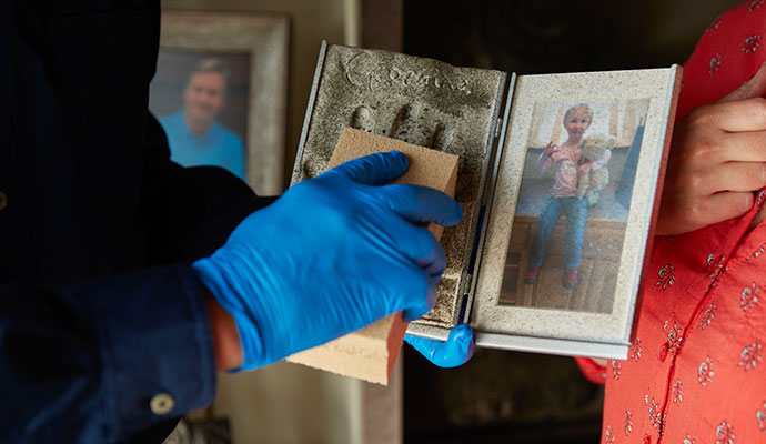 A person cleaning a photo frame