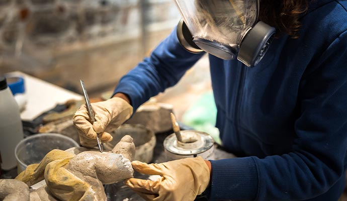 Professional cleaning a sculpture with equipment