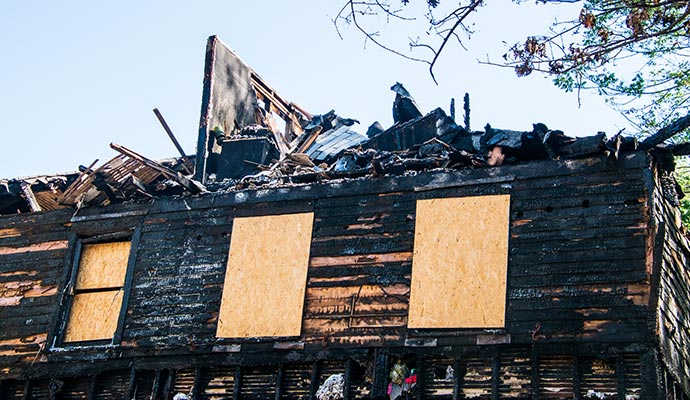 a boarded fire burnt house