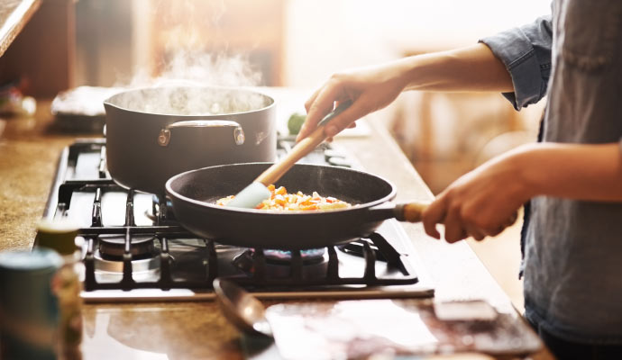 A person cooking on stove