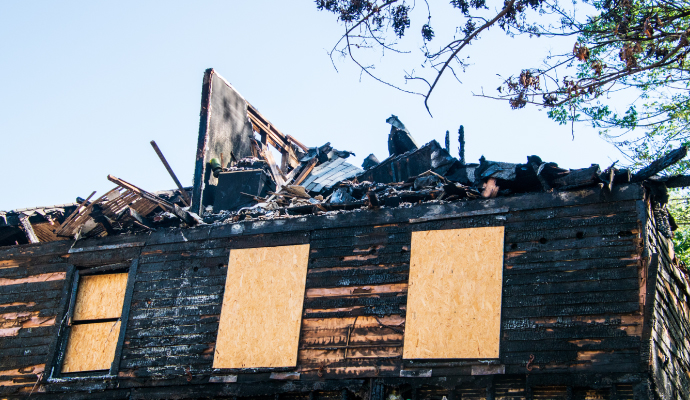 Fire damaged boarded-up house