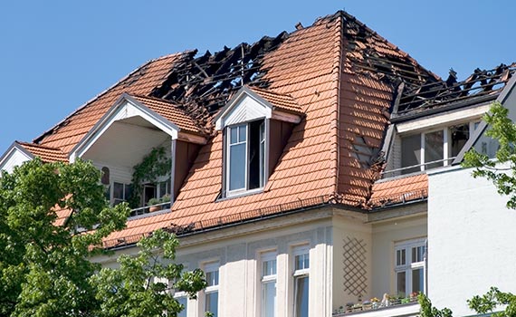 A fire damaged house,Roof damaged by fire.