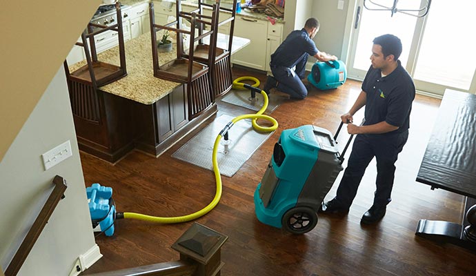 professional team restoring water damage with professional equipment